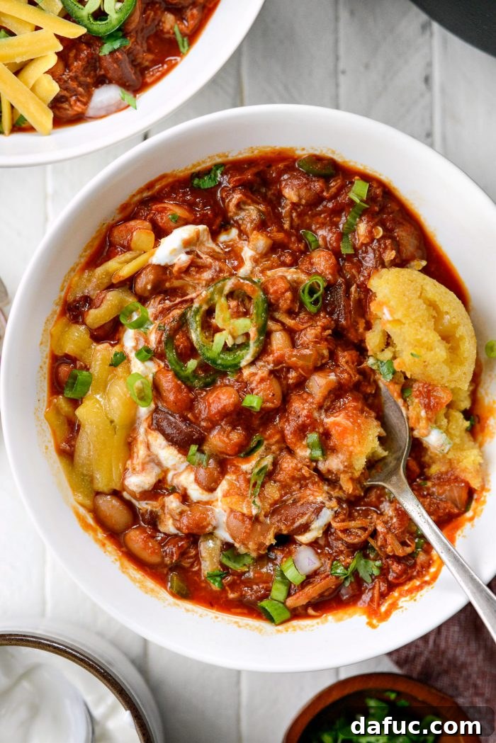 Fireside Smoky Pulled Pork Chili 18 A vibrant, close-up shot of Smoky Pulled Pork Chili, enticing and ready to eat