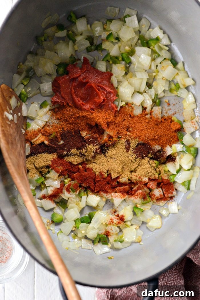 Fireside Smoky Pulled Pork Chili 7 Tomato paste and various spices added to the sautéed vegetables in the pot