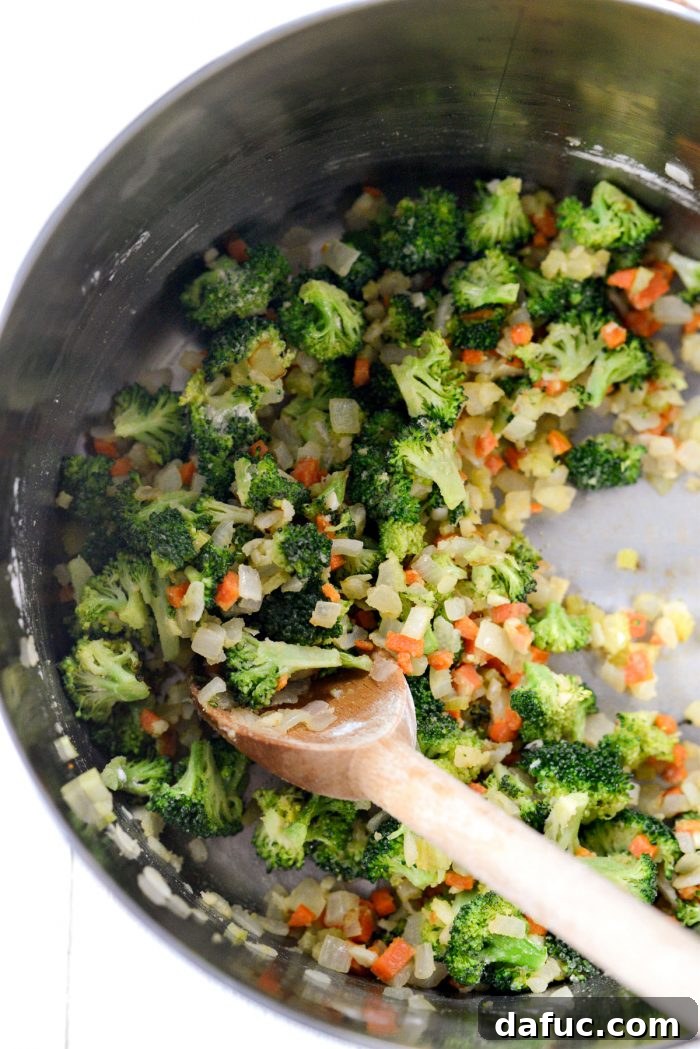 Hearty Ham, Swiss & Broccoli Delight 12 Flour being stirred into the vegetables to create a smooth, golden roux.