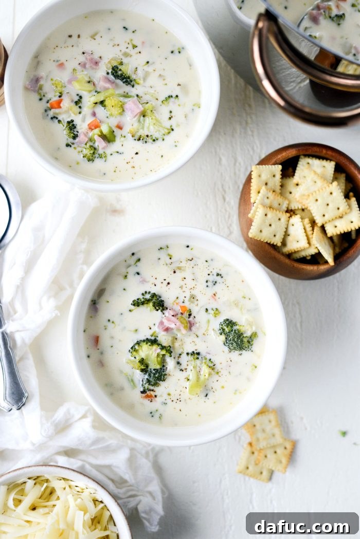 Hearty Ham, Swiss & Broccoli Delight 20 Broccoli Ham and Swiss Soup elegantly ladled into creamy white bowls, ready for serving.