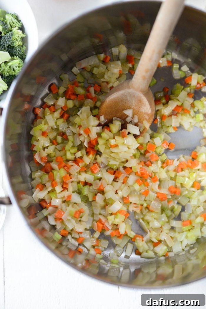 Hearty Ham, Swiss & Broccoli Delight 8 Sautéed aromatic vegetables simmering gently in the pot, forming a fragrant base.