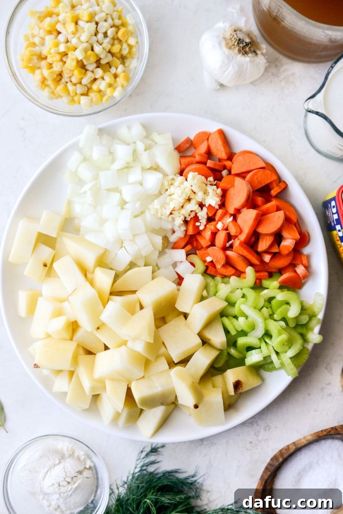 Coastal Catch Salmon Chowder 6 A cutting board with prepped vegetables: diced onion, sliced carrots, and chopped celery, ready for cooking.