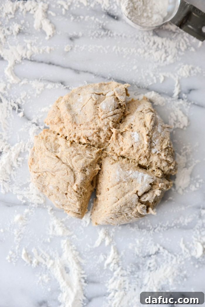 Delicious Air Fryer Pumpkin Spice Bagels 12 Bagel dough turned out onto a floured surface and divided into four equal portions.