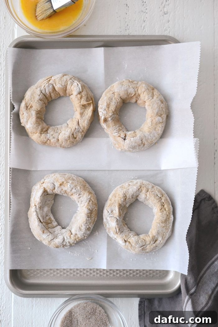 Delicious Air Fryer Pumpkin Spice Bagels 16 Four prepped bagel dough rings, ready for egg wash and topping.