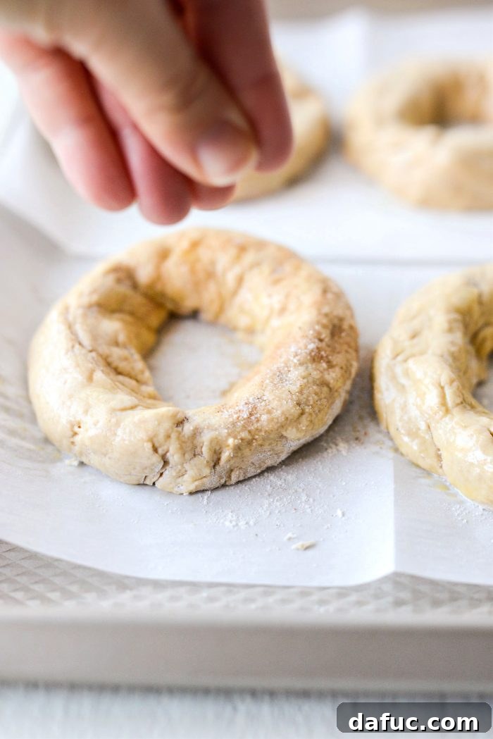 Delicious Air Fryer Pumpkin Spice Bagels 18 Sprinkling pumpkin spice sugar mixture onto an egg-washed bagel.