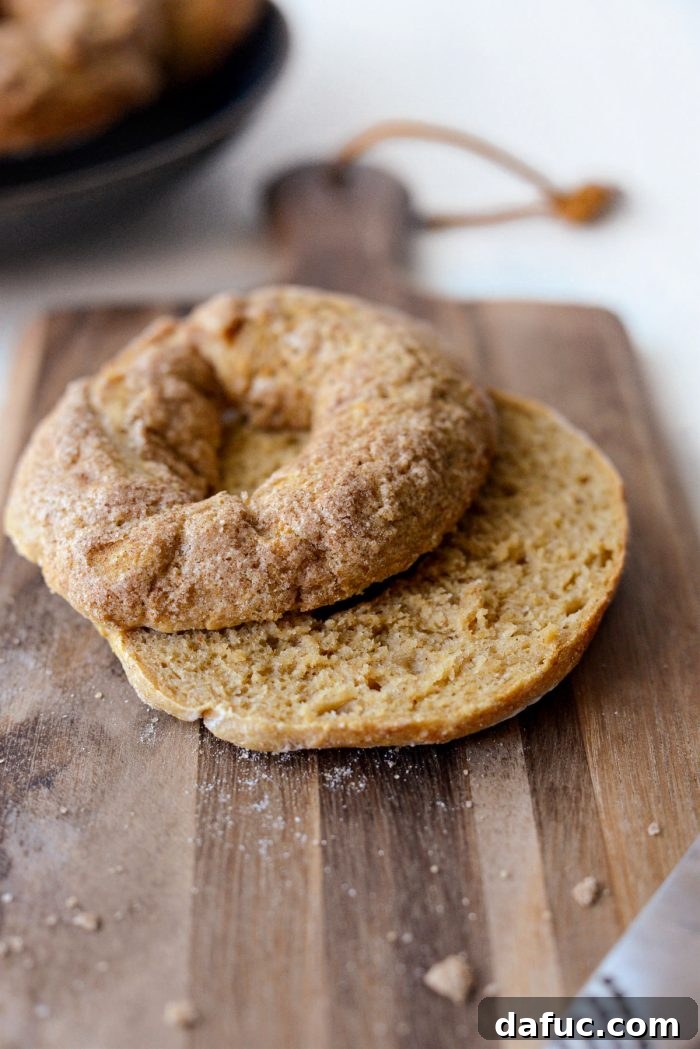 Delicious Air Fryer Pumpkin Spice Bagels 23 A freshly air-fried pumpkin spice bagel sliced in half, revealing its fluffy interior.