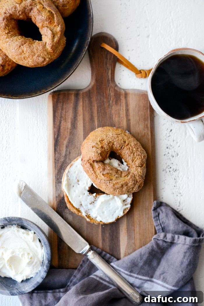 Delicious Air Fryer Pumpkin Spice Bagels 24 A toasted pumpkin spice bagel half, topped with whipped Greek yogurt cream cheese, ready to be enjoyed.