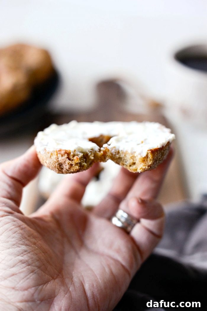 Delicious Air Fryer Pumpkin Spice Bagels 26 A stack of golden brown Air Fryer Pumpkin Spice Bagels with autumn leaves in the background.