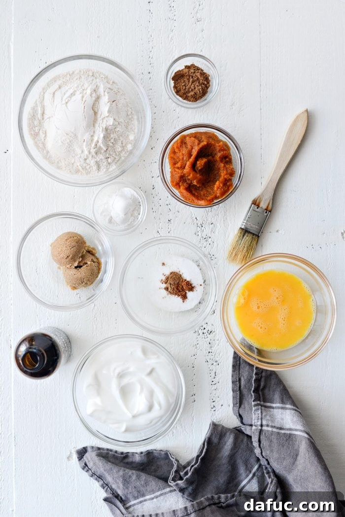 Delicious Air Fryer Pumpkin Spice Bagels 4 A collection of fresh ingredients laid out for making Air Fryer Pumpkin Spice Bagels, including flour, pumpkin puree, Greek yogurt, and spices.