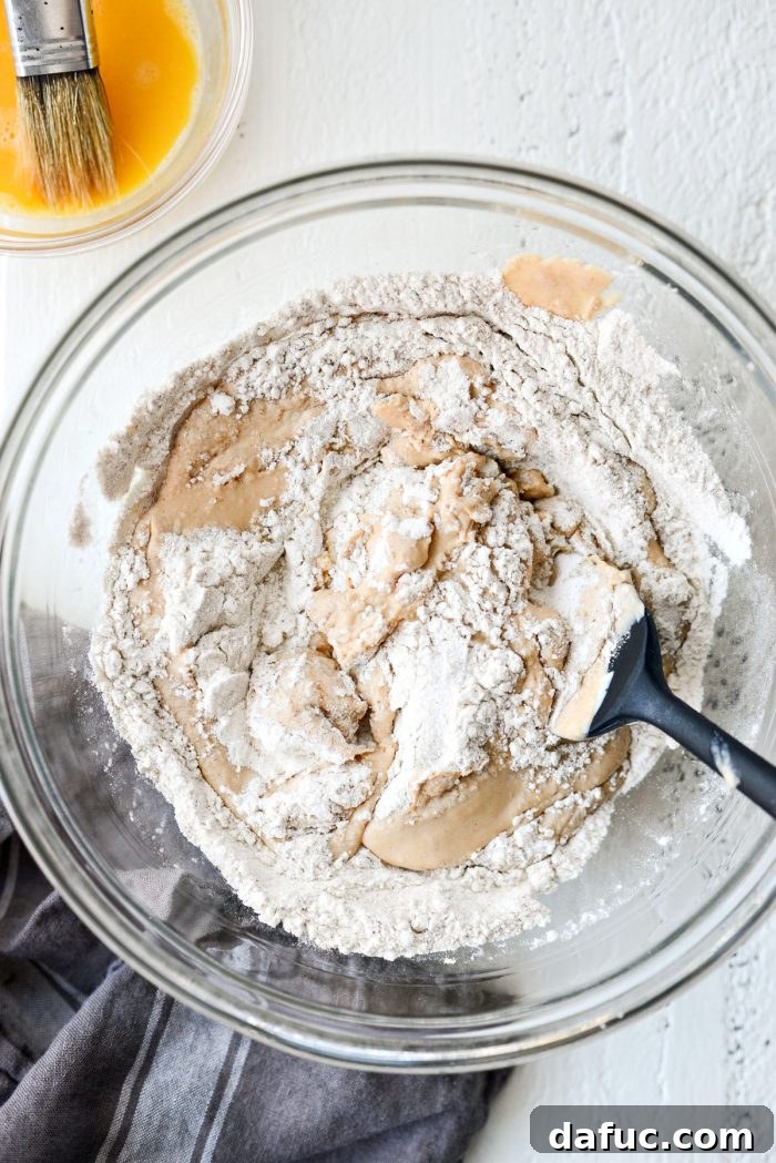Delicious Air Fryer Pumpkin Spice Bagels 10 Mixing the wet and dry ingredients with a spatula to form the bagel dough.