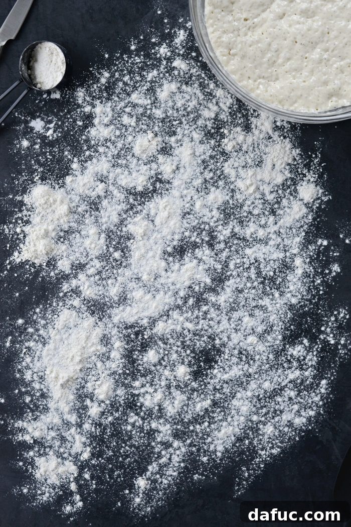 A generously floured work surface, ready for dough handling.
