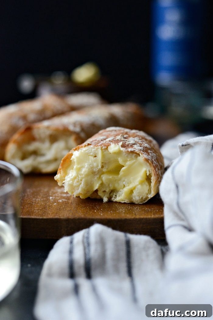 Two slices of No-Knead French Bread with butter, ready to be enjoyed.