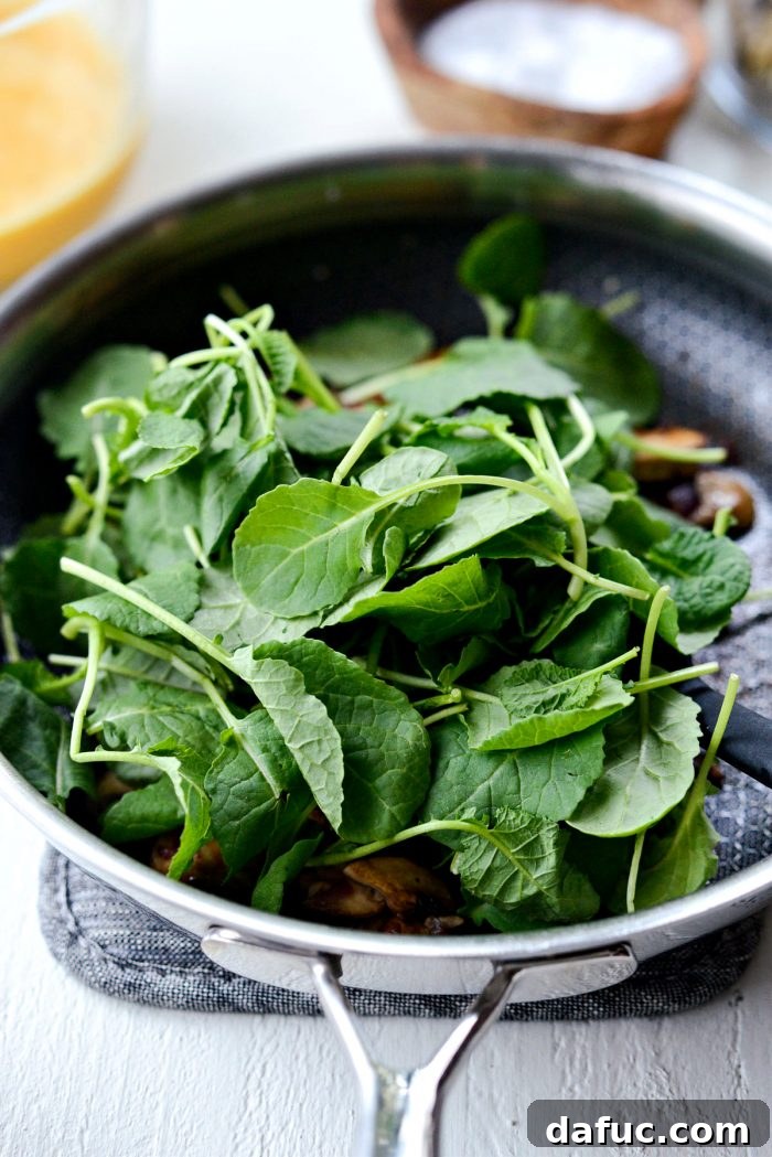 baby kale added to skillet.