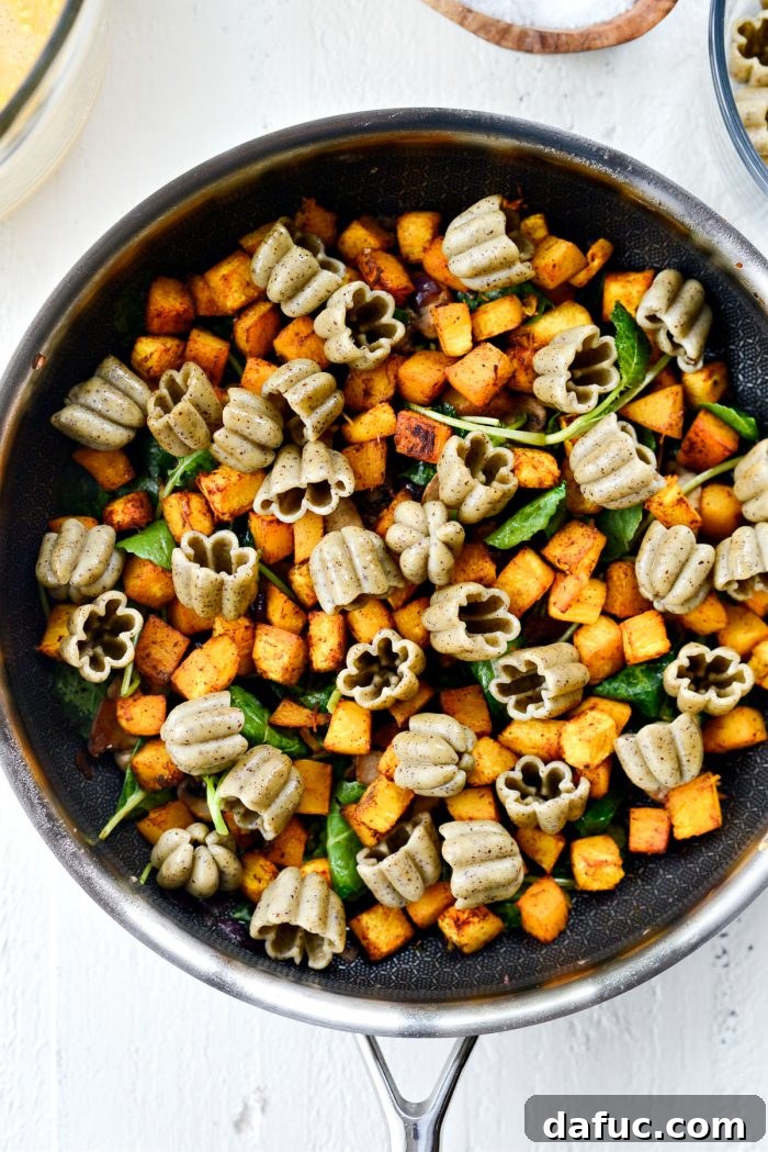 roasted pumpkin and pasta added to skilelt.