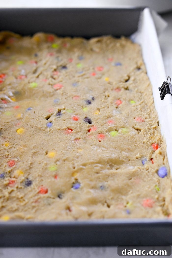 Halloween Haul Cookie Bars 16 Cookie dough perfectly pressed into the baking pan, creating an even layer.