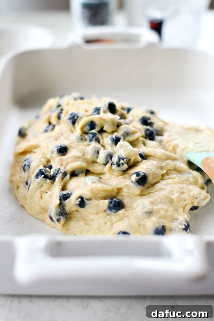 Transferring cake batter to the prepared baking pan