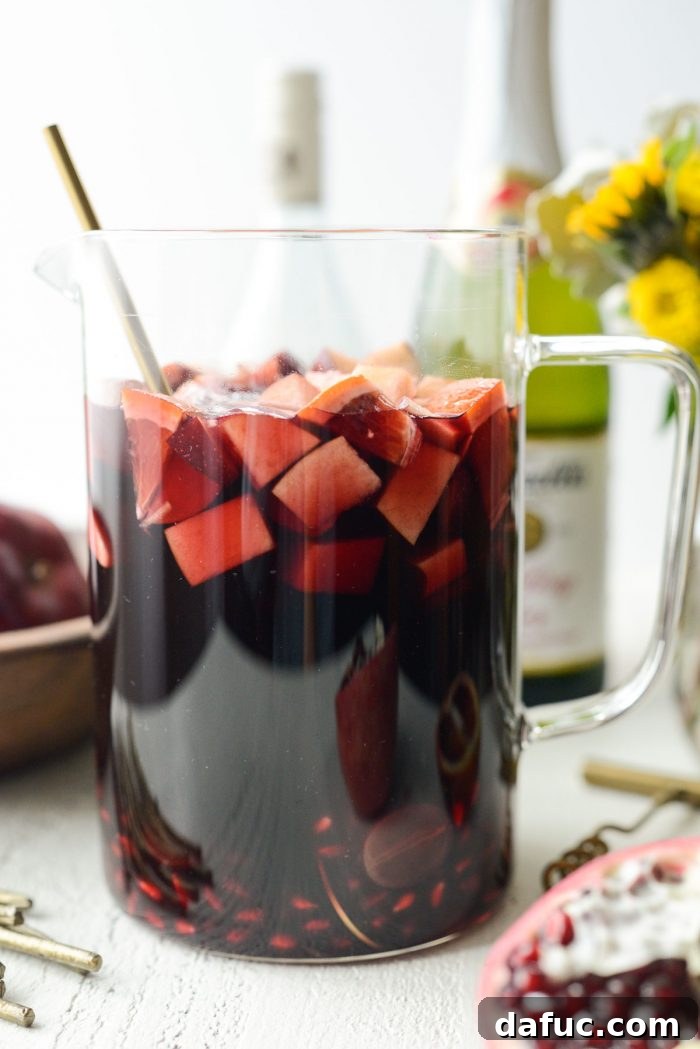 Ruby Fizz Sangria 2 Pitcher of Pomegranate Sparkling Apple Cider Sangria ready for serving