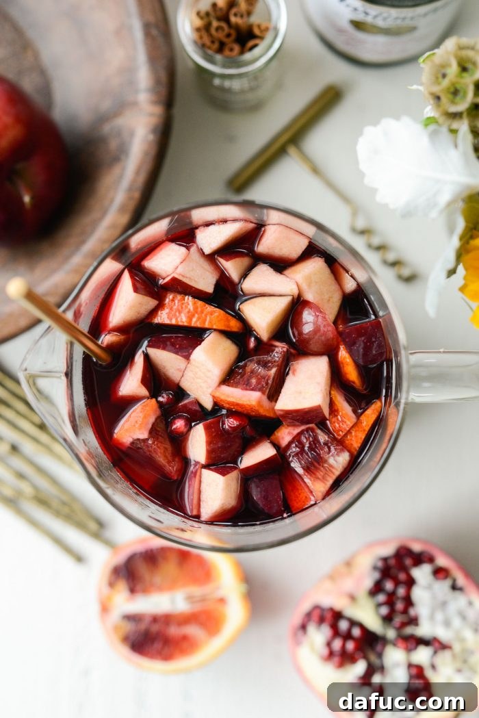 Pomegranate Sparkling Apple Cider Sangria chilling in a pitcher in the refrigerator