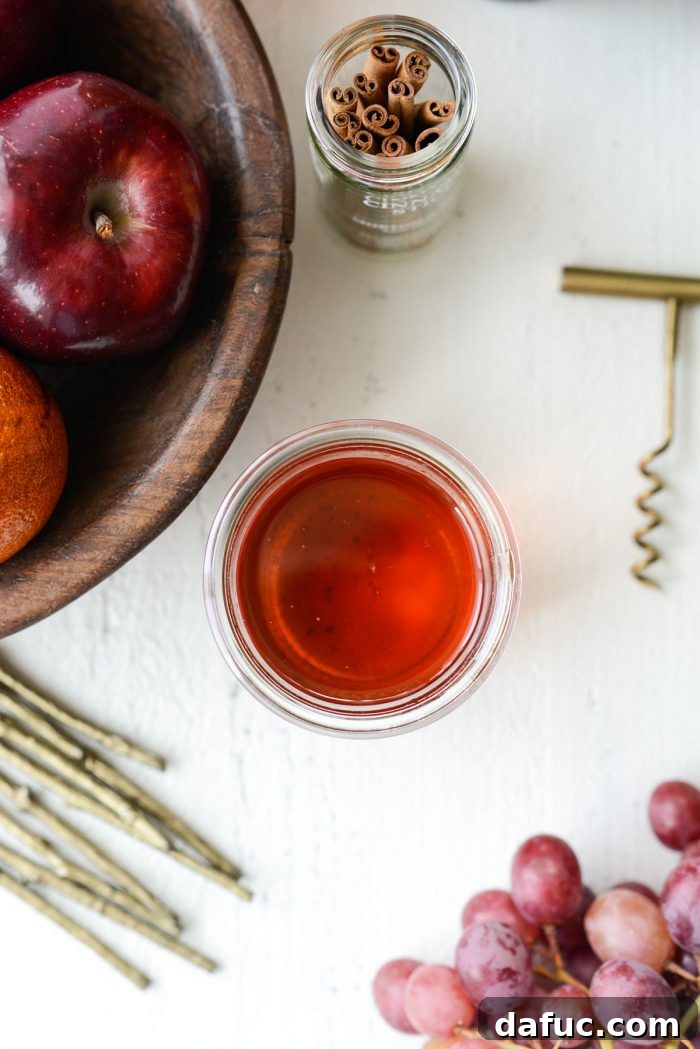 Ruby Fizz Sangria 6 Cinnamon simple syrup cooling in a jar