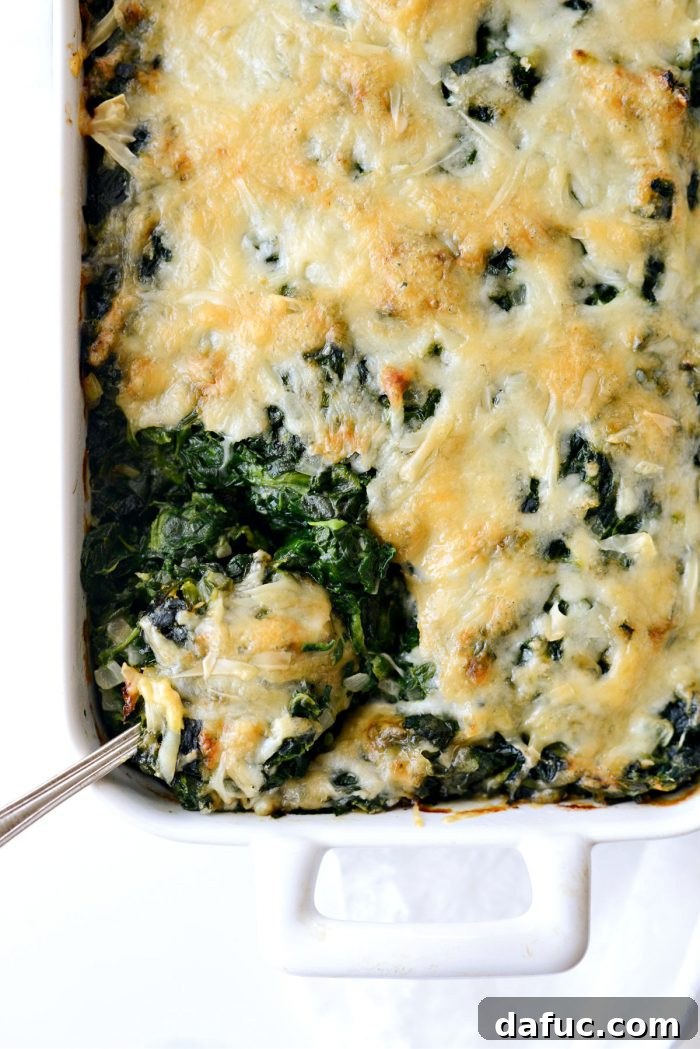 Delicious creamy Spinach Gratin served in a white dish, ready for the holiday table.