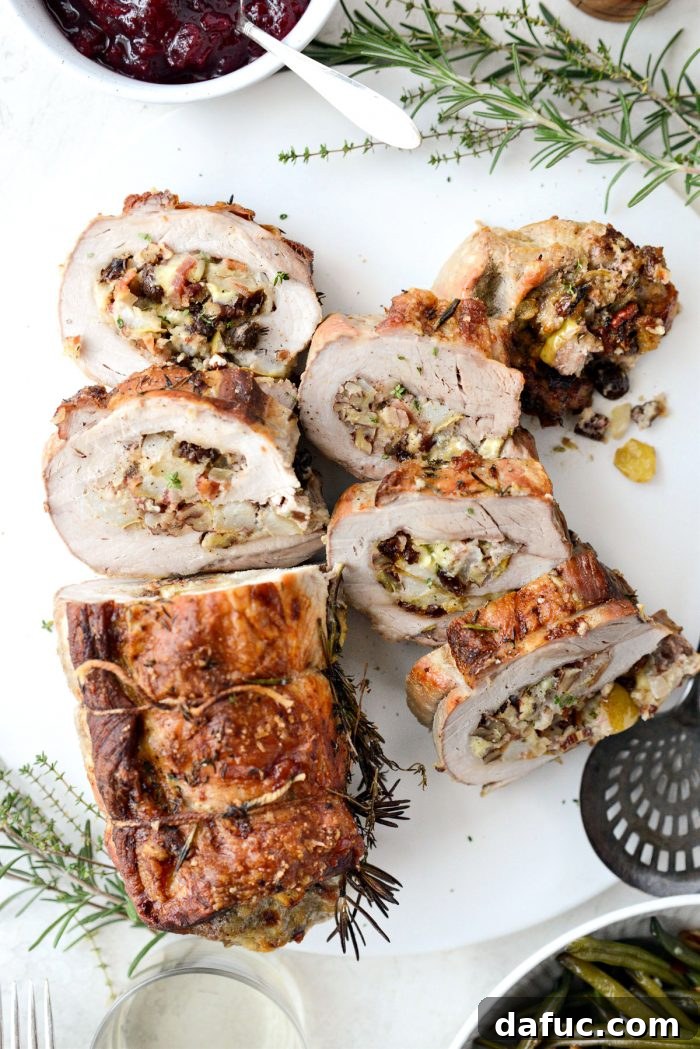 Sweet Pear, Savory Bacon, and Tangy Blue Cheese Stuffed Pork Loin 18 Plated Bacon Pear and Blue Cheese Stuffed Pork Loin with side dishes