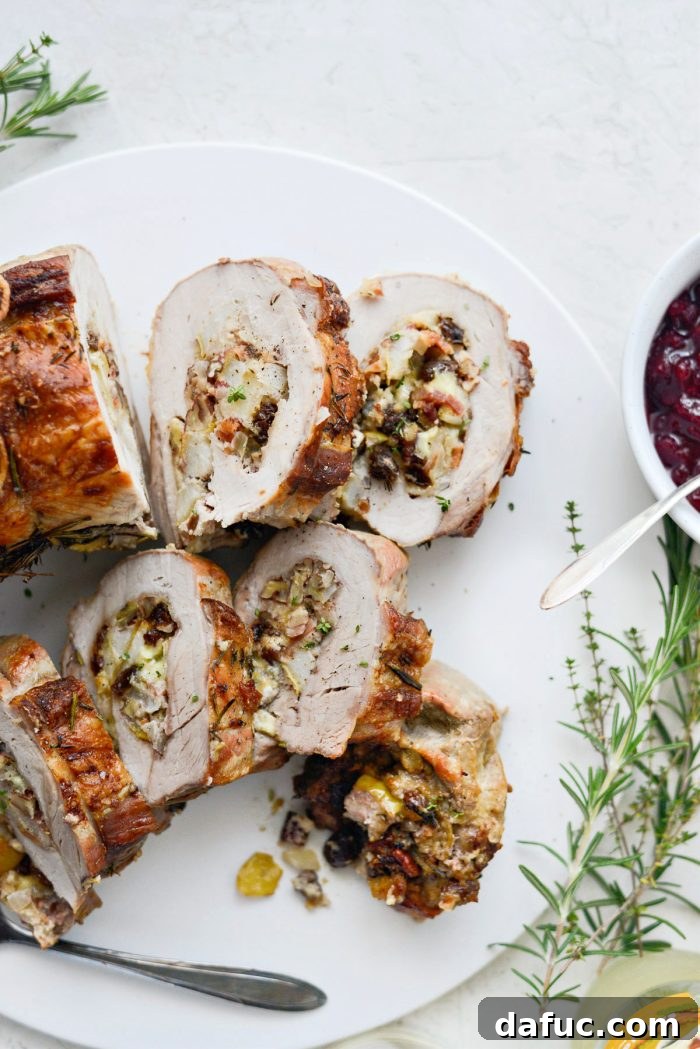Stuffed pork loin cooking in a roasting pan
