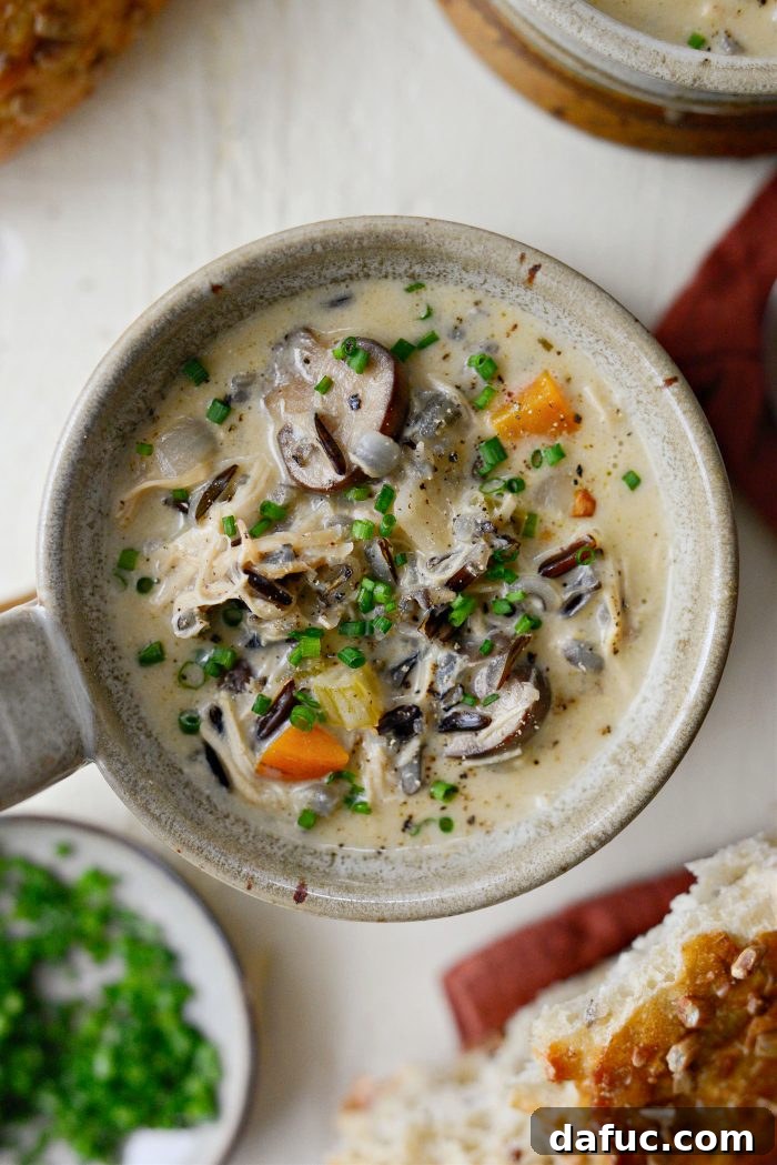 A rich and creamy bowl of Turkey Mushroom Wild Rice Soup, generously loaded with leftover turkey, earthy mushrooms, tender vegetables, and nutty wild rice.