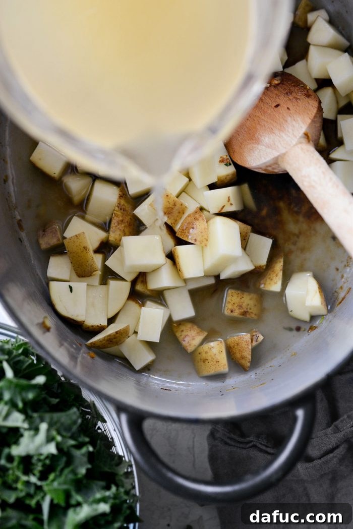 Diced potatoes, chicken broth, and water added to the Dutch oven.