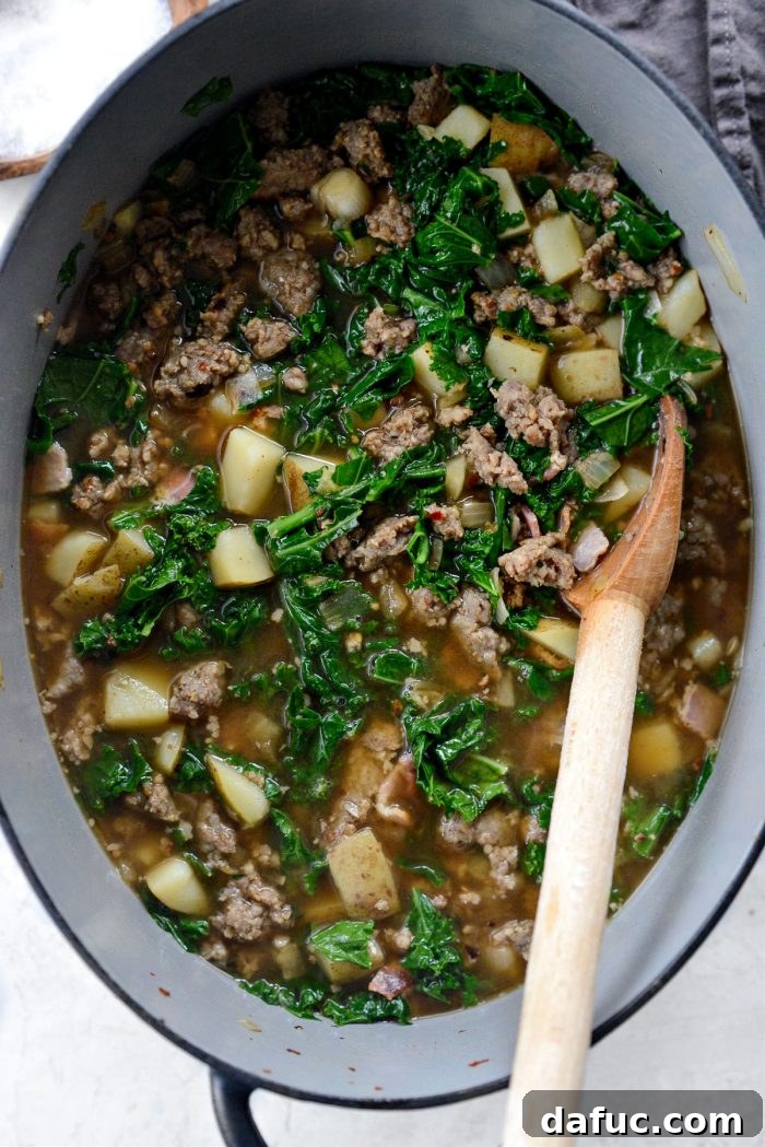 Wilted kale in the simmering Zuppa Toscana soup.
