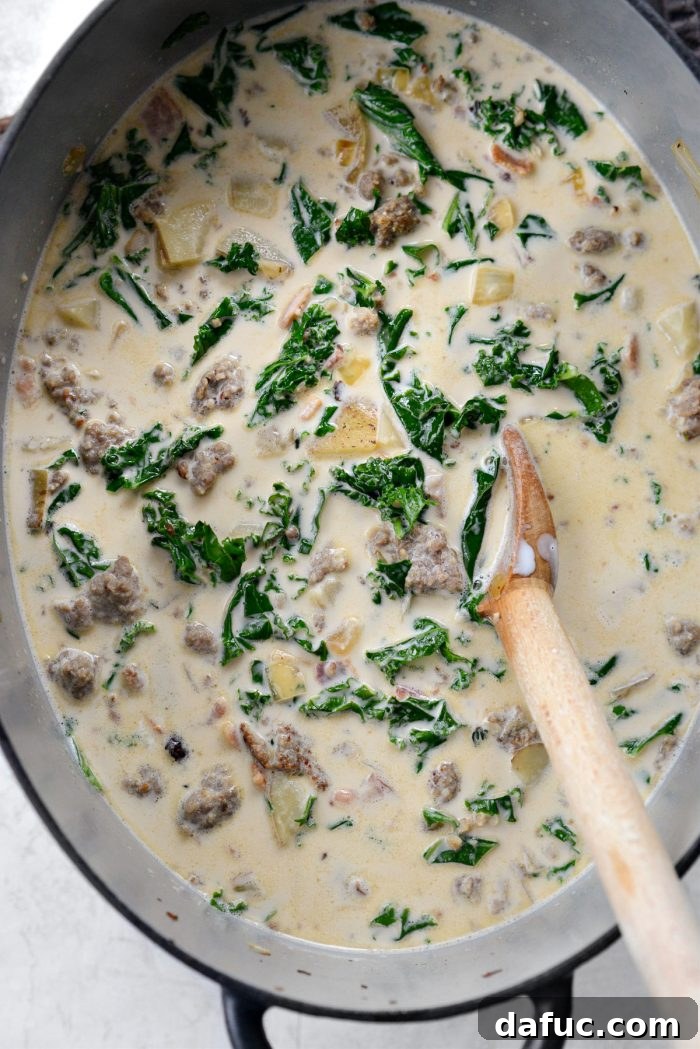 Stirring the Zuppa Toscana soup to combine all ingredients.