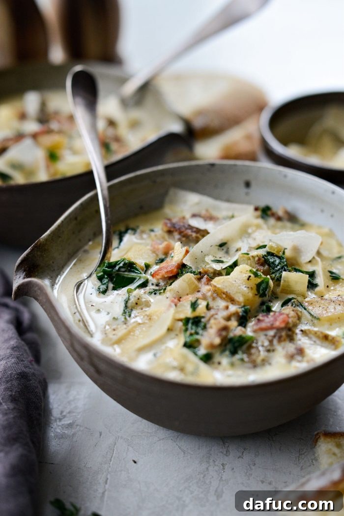 A rustic grey-brown bowl filled with homemade Zuppa Toscana, ready to be enjoyed.