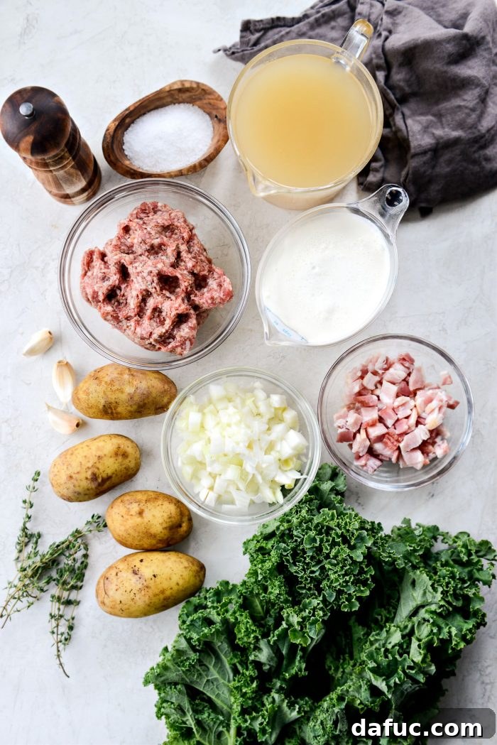 Various fresh ingredients for Zuppa Toscana laid out on a wooden surface, including kale, potatoes, sausage, and bacon.