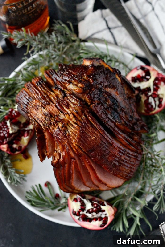 Jeweled Pomegranate Bourbon Glazed Ham 18 The fully cooked Pomegranate Bourbon Glazed Ham carefully transferred to a wooden carving board, ready to be sliced and served.