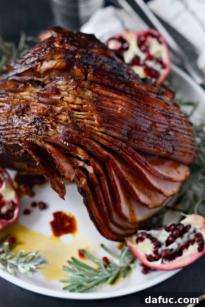 Jeweled Pomegranate Bourbon Glazed Ham 20 A close-up shot of the Pomegranate Bourbon Glazed Ham, emphasizing the moist, tender slices and the rich, sticky glaze.