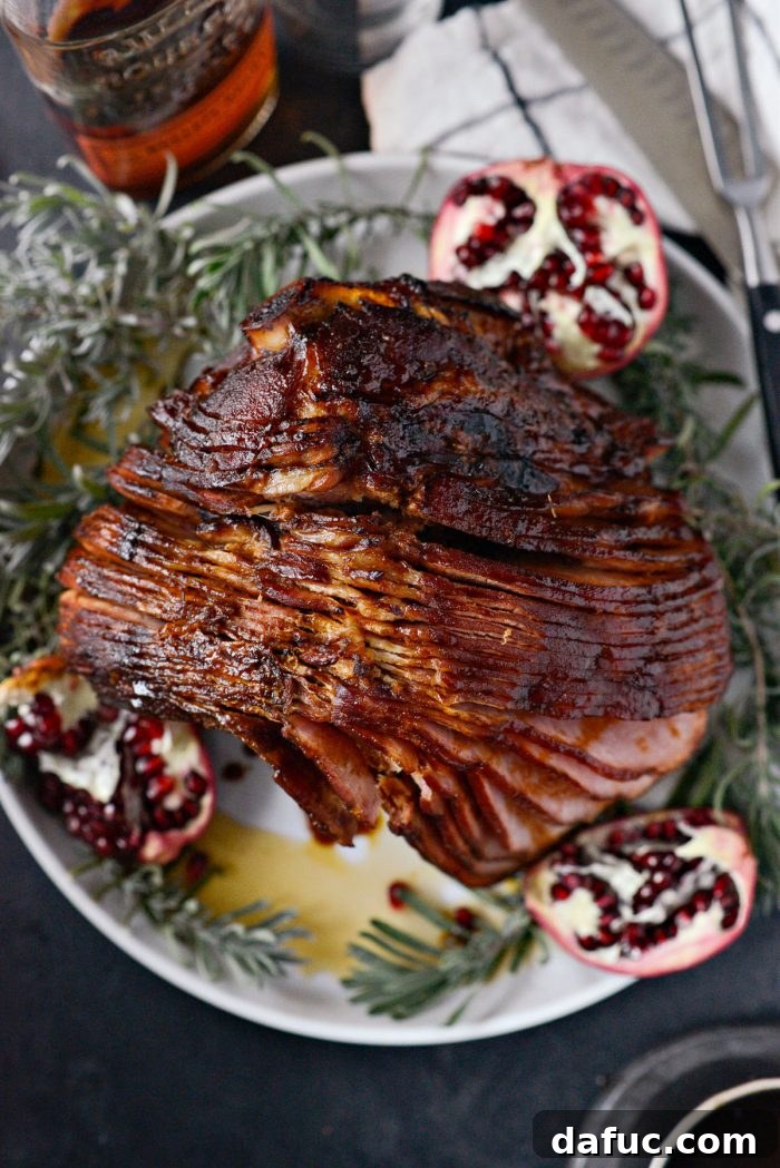 Jeweled Pomegranate Bourbon Glazed Ham 21 Pomegranate Bourbon Glazed Ham on a clean white platter, showing a perfectly cooked ham ready to be served.