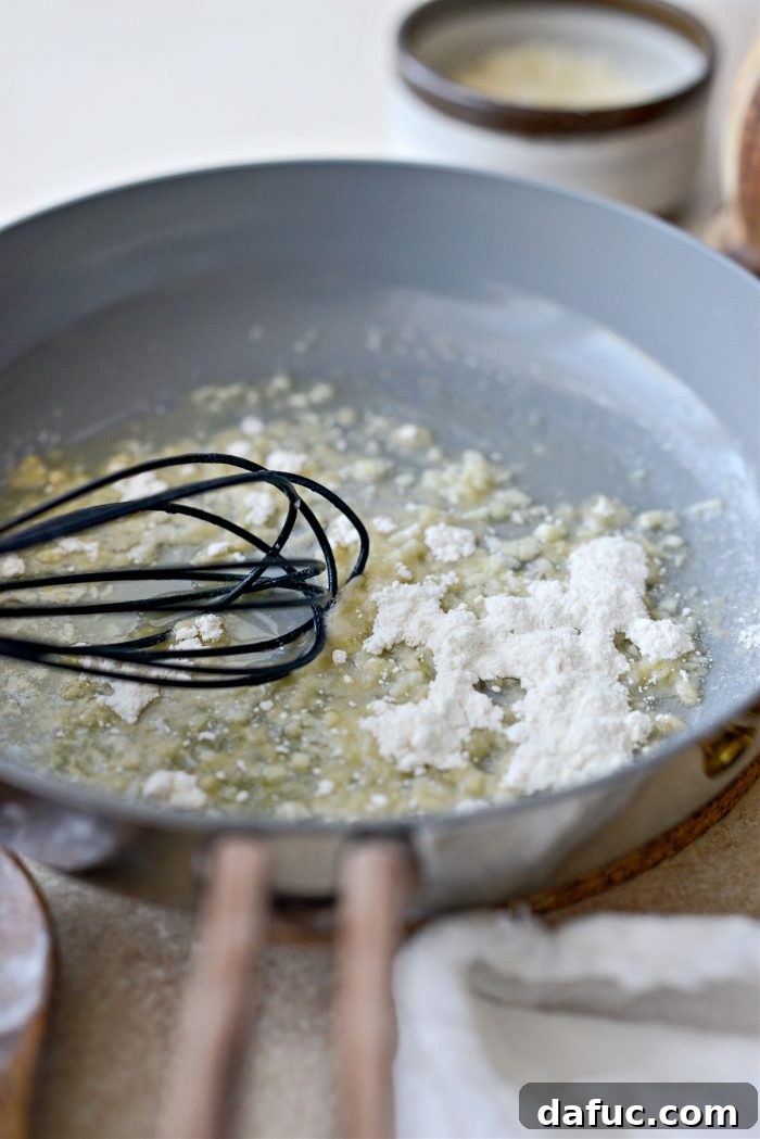 Golden Garlic Parmesan Corn Gratin 12 Whisking flour into melted butter and garlic for a roux