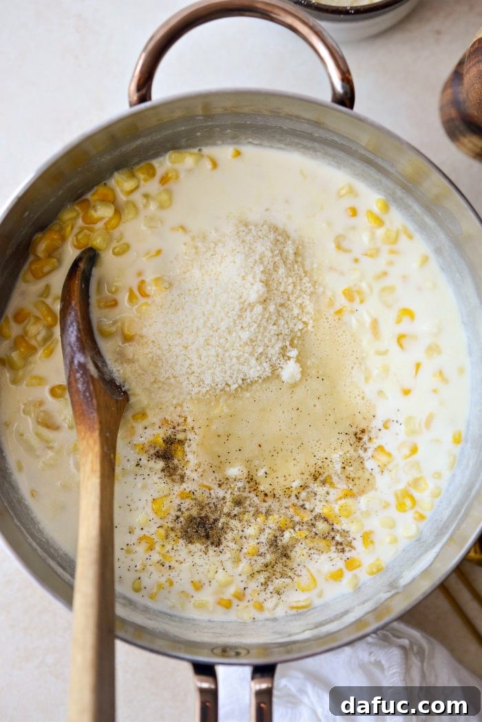 Golden Garlic Parmesan Corn Gratin 14 Adding roux, parmesan cheese, and black pepper to corn and cream mixture