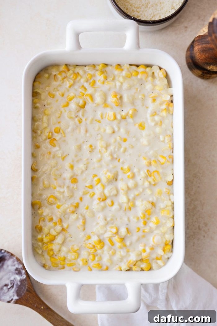 Golden Garlic Parmesan Corn Gratin 16 Transferring creamy corn mixture to a casserole dish