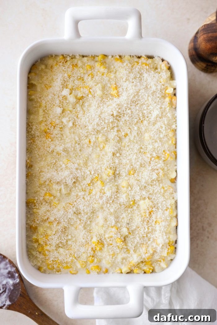 Golden Garlic Parmesan Corn Gratin 17 Sprinkling remaining Parmesan cheese over the corn au gratin in a casserole dish