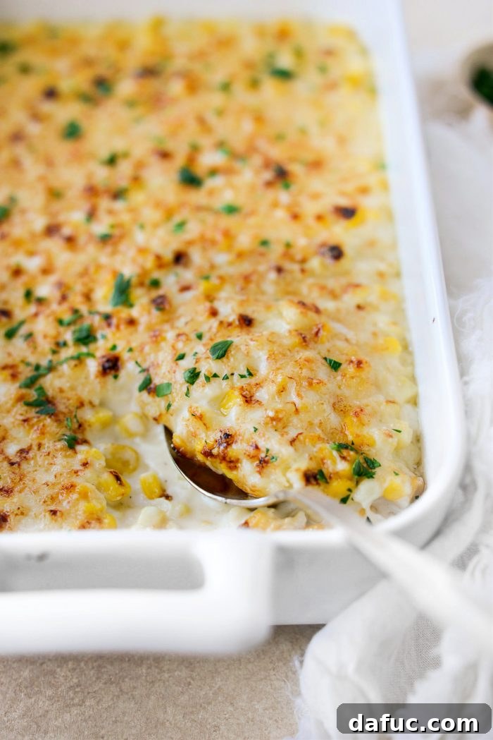 Golden Garlic Parmesan Corn Gratin 3 A serving of creamy Parmesan Garlic Corn Au Gratin scooped from a dish