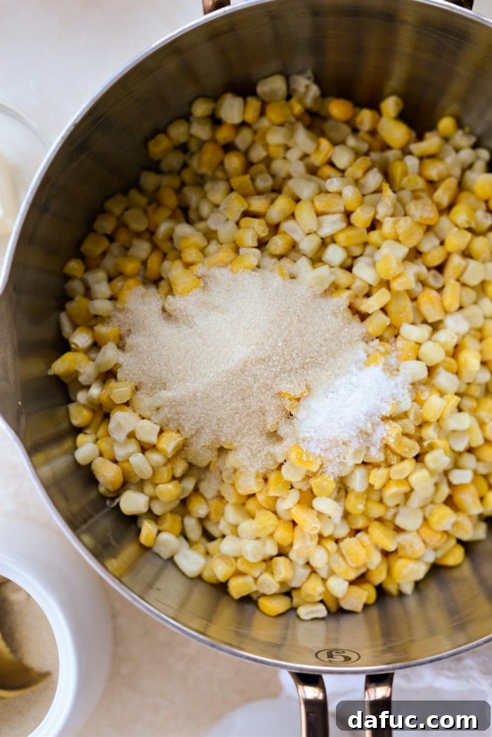 Golden Garlic Parmesan Corn Gratin 6 Adding sugar and kosher salt to sweet corn in a saucepan