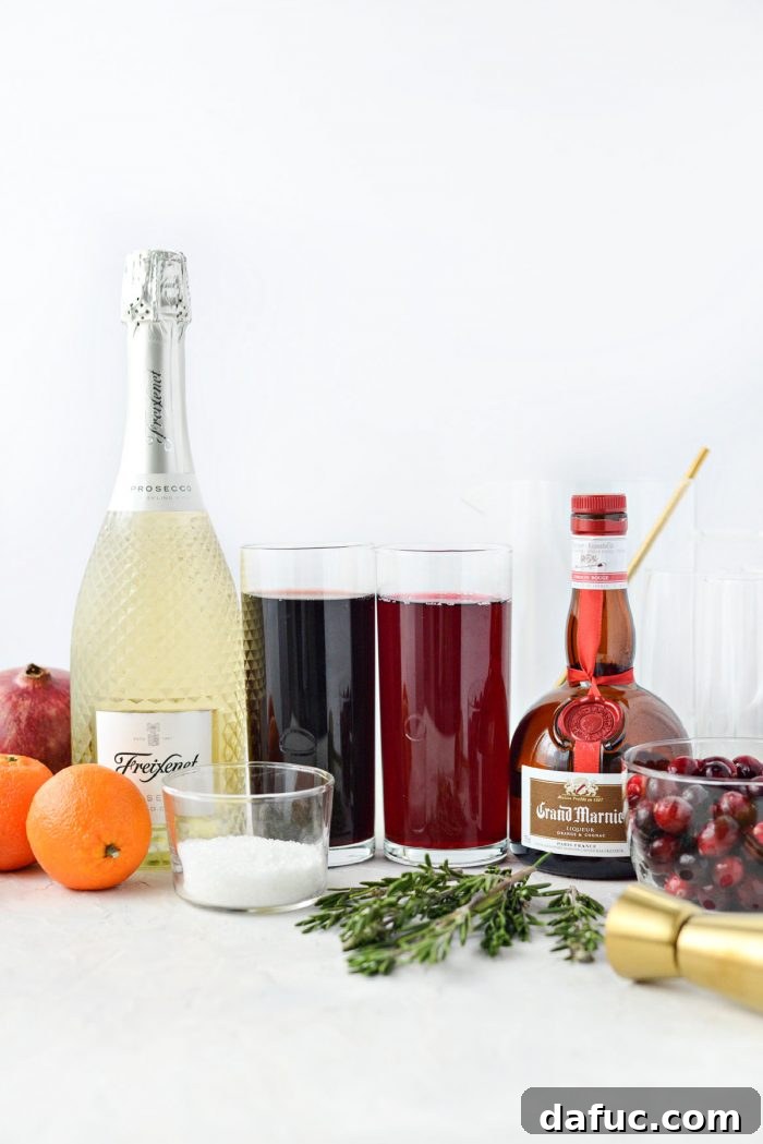 Bright & Bubbly Christmas Mornings 4 Ingredients laid out for Christmas Morning Mimosas, including cranberries, pomegranates, clementines, juices, and spirits