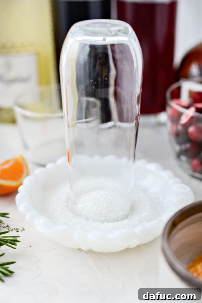 Bright & Bubbly Christmas Mornings 5 Dipping the rim of a champagne glass in sparkling sugar using a clementine wedge