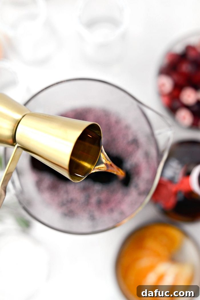 Bright & Bubbly Christmas Mornings 9 Adding Grand Marnier liqueur to the pitcher of mixed juices