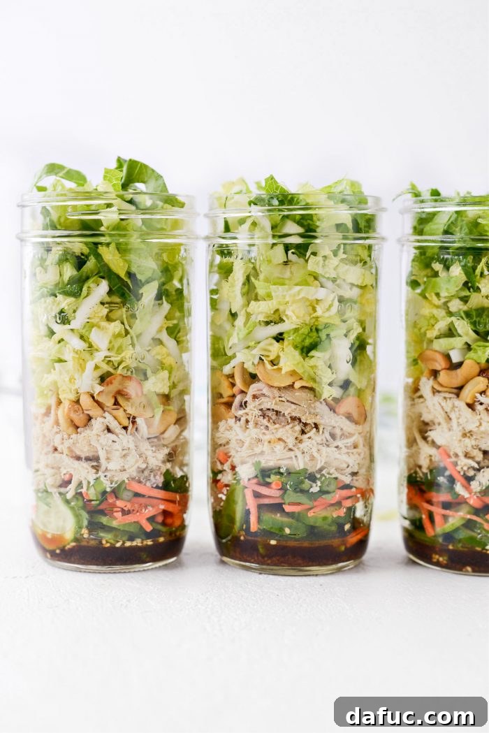 Final layer of cabbage and romaine lettuce visible in the mason jar salad.