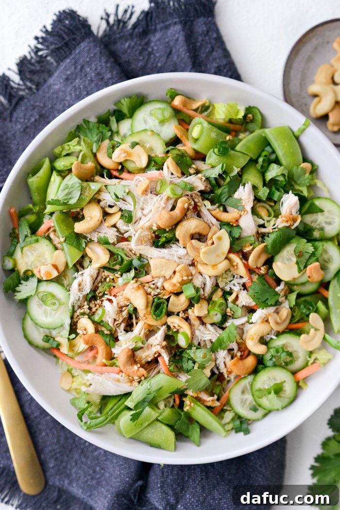Asian Cashew Chicken Mason Jar Salad served in an elegant cream bowl.