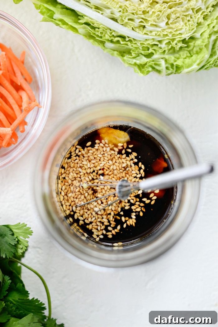 Homemade toasted sesame dressing in a small jar, ready for mason jar salads.