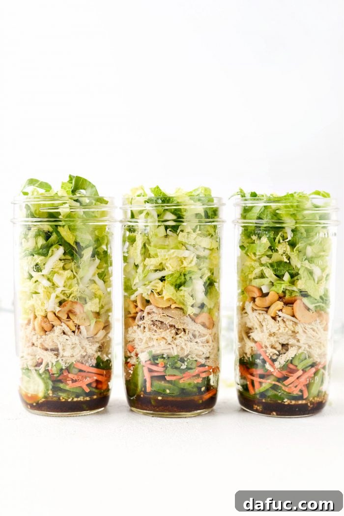 Last step in assembling the mason jar salad: adding Napa cabbage and romaine lettuce.