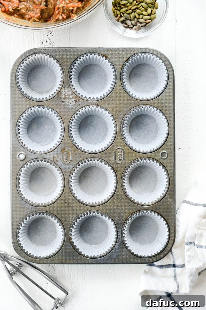 Muffin pan lined with paper liners, ready for batter.