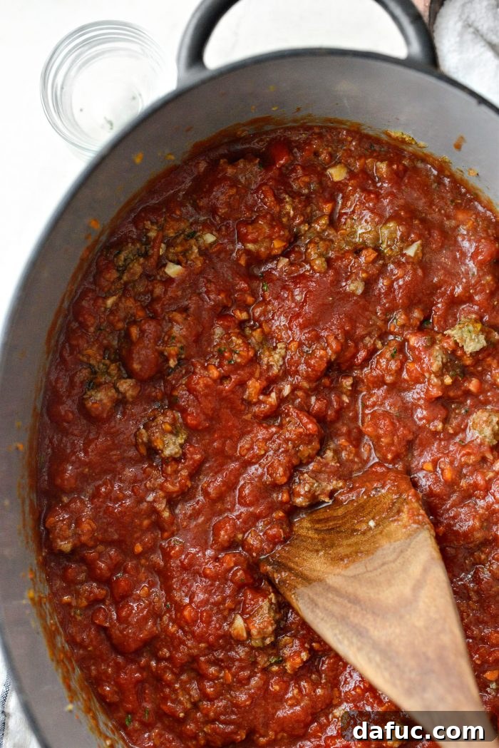Slow Roasted Spaghetti Sauce 13 Stirring the tomato products into the meat and vegetable sauce in a Dutch oven.